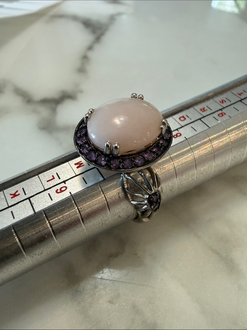 Women’s silver halo ring with pink and purple stones